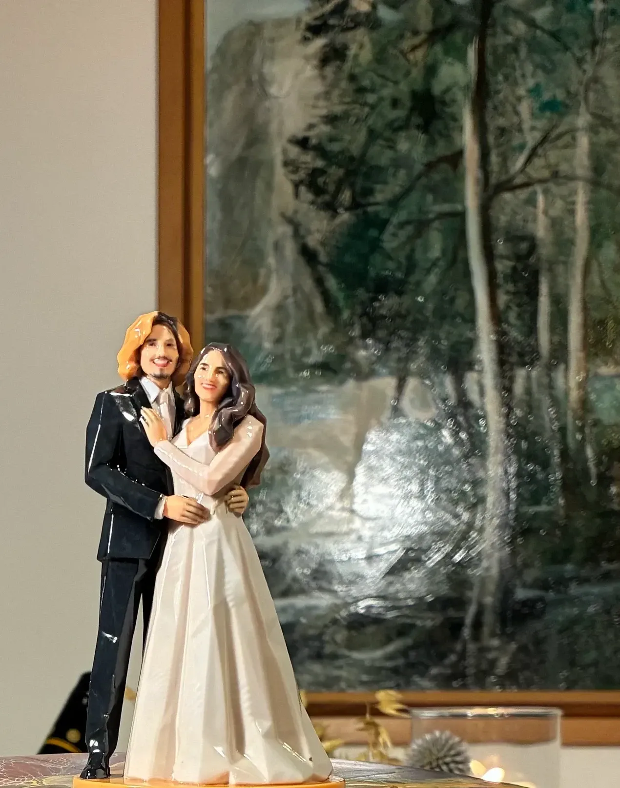 Printed Origami groom in a black suit and bride in a lace gown in a side hold on top of a cake.