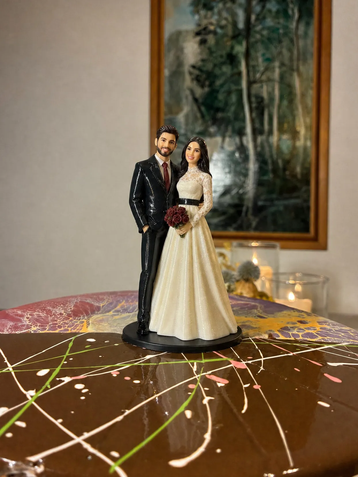 The same couple: she in an ivory lace gown with a black sash and dark red roses, he in a black suit with a red tie.