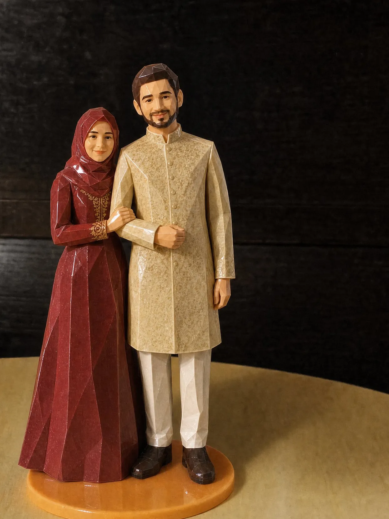 The same couple as a topper on an orange base. The bride wears a deep red hijab and a long-sleeved red dress with gold trim. The groom wears an embroidered gold sherwani and ivory trousers.